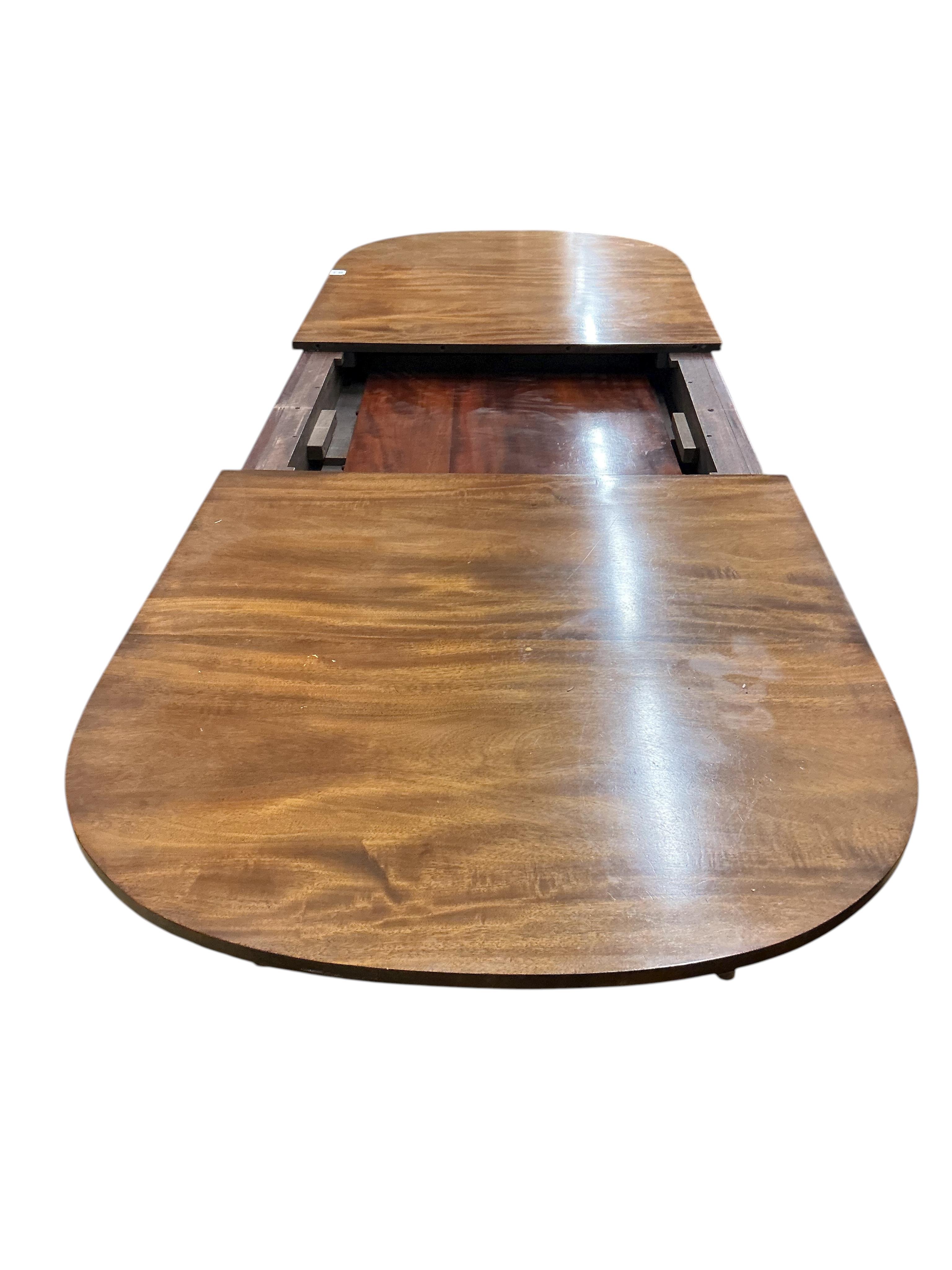 A reproduction Sheraton style mahogany extending dining table, 260cm extended, one spare leaf, width 91cm, height 76cm